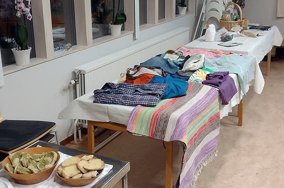 Ett bord med hållbart fika och ett bord med utställning av långlivade kläder