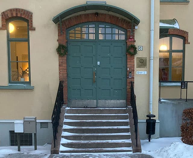Den stora entrédörren har en skylt bredvid, som det står C på.